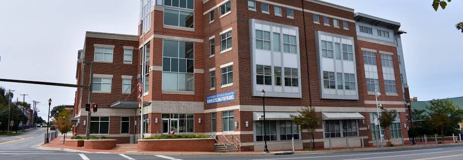 Exterior of the Frederick County Public Schools administrative office building in Frederick, Maryland, featuring a brick facade and large windows.